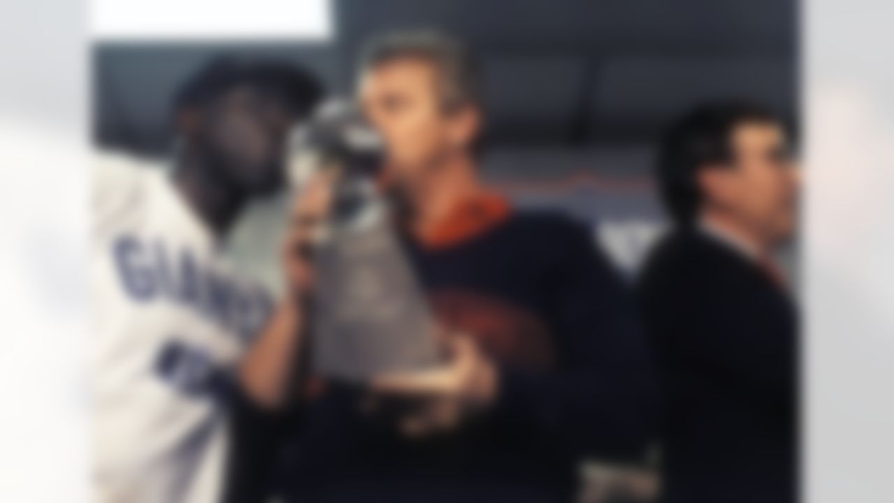 New York Giants coach Bill Parcells and running back Ottis Anderson kiss the Super Bowl XXV trophy after the Giants 20 - 19 win over the Buffalo Bills January 27, 1991 in Tampa Florida. (AP Photo/Al Messerschmidt)
