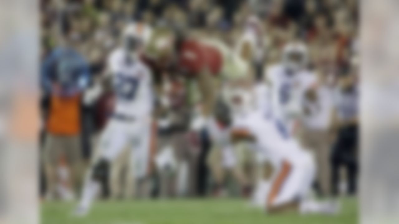 Auburn's Jermaine Whitehead (9) trips Florida State's Kelvin Benjamin after a catch. (AP Photo/David J. Phillip)