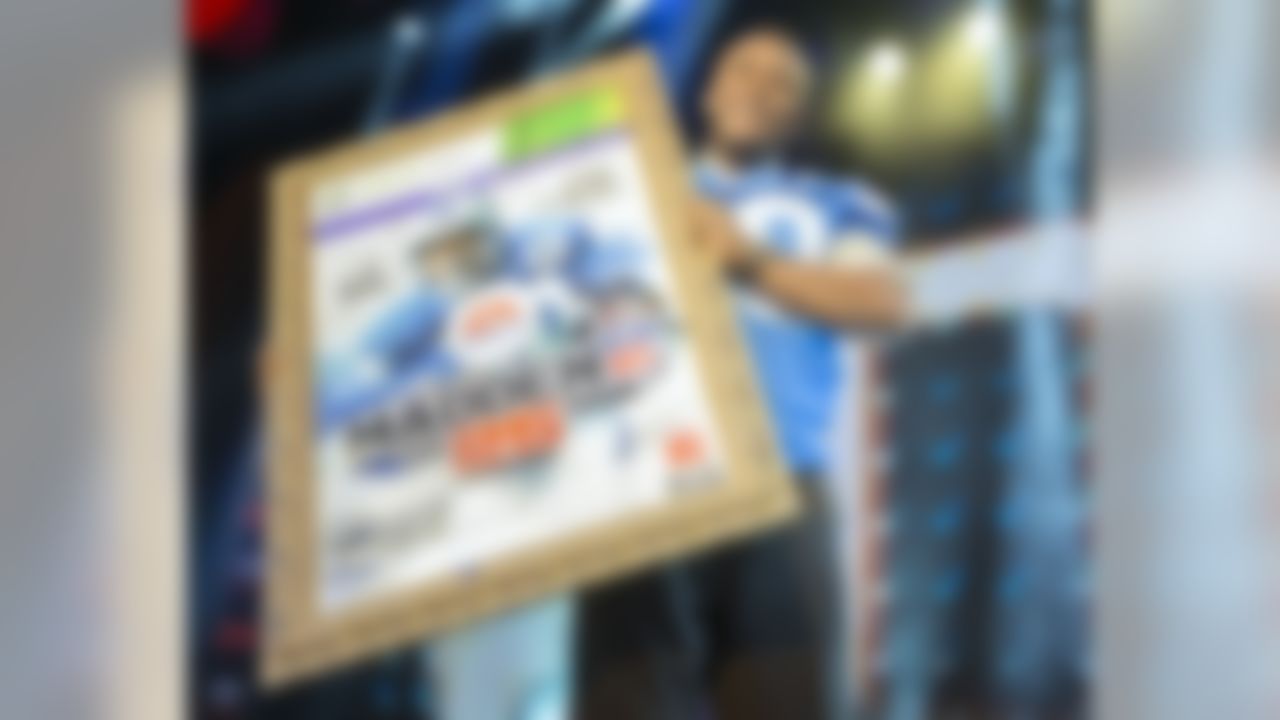 IMAGE DISTRIBUTED FOR EA SPORTS - NFL hall of fame running back Barry Sanders holds up a mock up of the Madden 25 video game cover during the EA Sports Madden NFL 25 Cover Reveal on SportsNation on Wednesday, April, 24, 2013 in New York, New York. (Photo by Chris Park/Invision for EA Sports/AP Images)