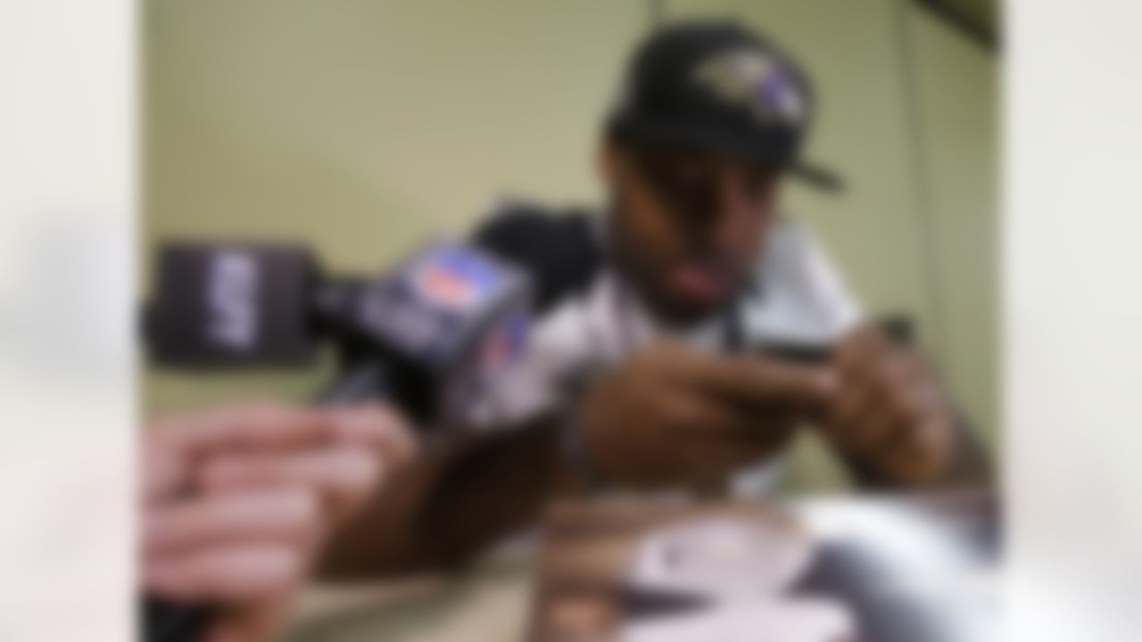 Baltimore Ravens linebacker Terrell Suggs reads tweets from his phone as he speaks at an NFL Super Bowl XLVII news conference on Thursday, Jan. 31, 2013, in New Orleans. The Ravens face the San Francisco 49ers in Super Bowl XLVII on Sunday, Feb. 3. (AP Photo/Patrick Semansky)