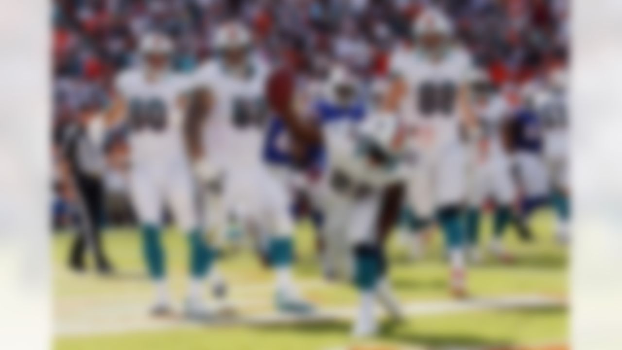 Miami Dolphins running back Reggie Bush (22) spikes the ball after a touchdown during the first half of an NFL football game against the Buffalo Bills, Sunday, Dec. 23, 2012, in Miami. (AP Photo/John Bazemore)