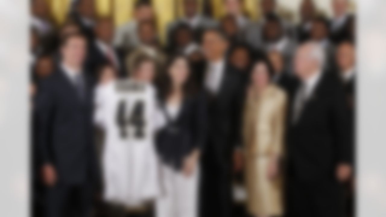 President Barack Obama stands with, from left: New Orleans Saints football quarterback Drew Brees, Saints part owner Rita Benson LeBlanc, the owner's wife Gayle Benson, and team owner Tom Benson, as he welcomes the 2009 NFL Super Bowl NFL Football Champions New Orleans Saints during a ceremony in the East Room of the White House in Washington, Monday, Aug. 9, 2010. (AP Photo/Charles Dharapak)