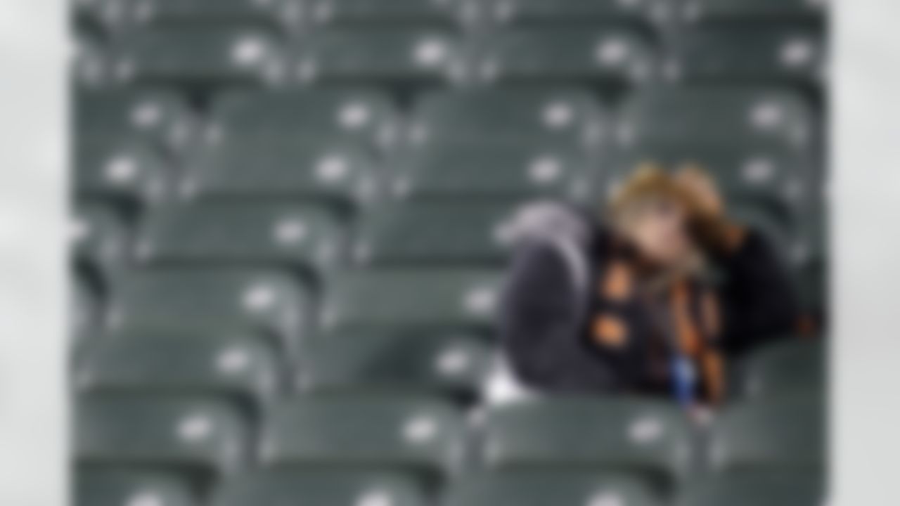 A Cincinnati Bengals fan sits in the empty stands after the New York Jets defeated the Bengals 24-14 during an NFL wild-card playoff football game, Saturday, Jan. 9, 2010, in Cincinnati. (AP Photo/Rob Carr)