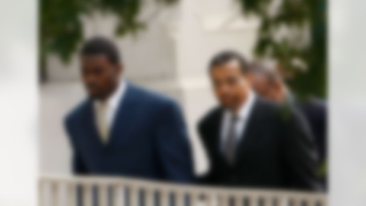 RICHMOND, VA - AUGUST 27: Atlanta Falcons quarterback Michael Vick (L) arrives at federal court August 27, 2007 in Richmond, Virginia. The football star was expected to plead guilty to a federal dogfighting conspiracy charge. The NFL has suspended Vick indefinitely. (Photo by Win McNamee/Getty Images)
