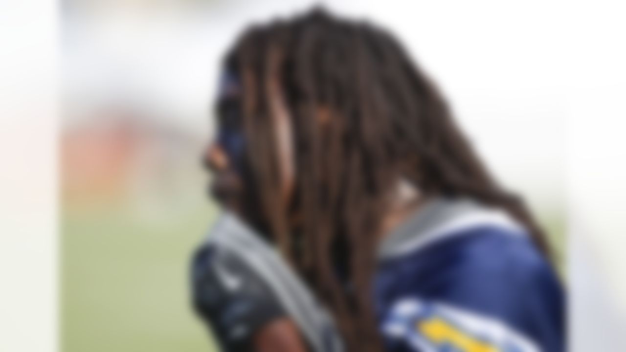 San Diego Chargers defensive back Atari Bigby uses his shirt to wipe away the sweat during practice at NFL football training camp, Thursday, July 26, 2012, in San Diego. (AP Photo/Lenny Ignelzi)