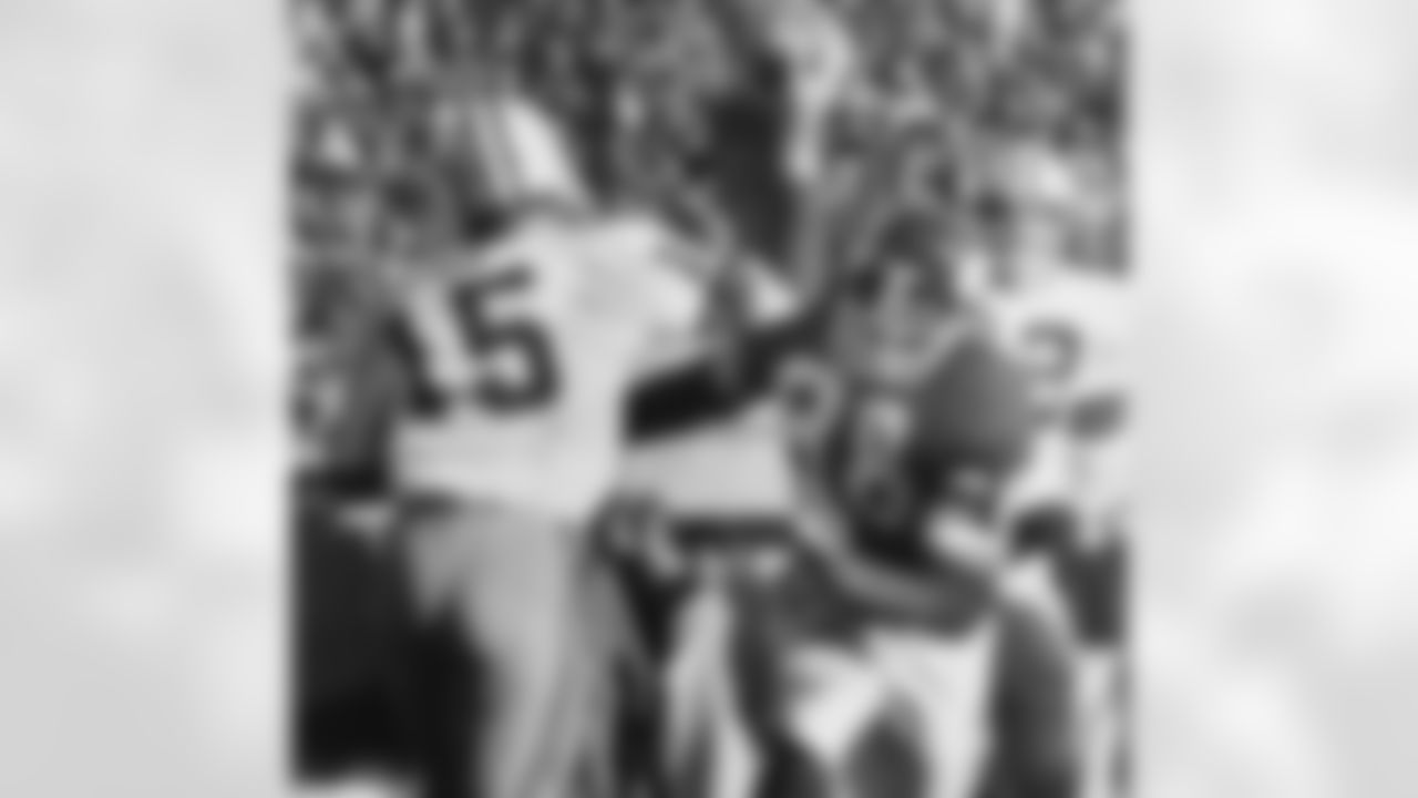 This Nov. 23, 1970, file photo shows Green Bay Packers quarterback Bart Starr (15) looking for a receiver as Minnesota Vikings' Alan Page (88) charges him during second half action of an NFL game in Minneapolis. (AP Photo)
