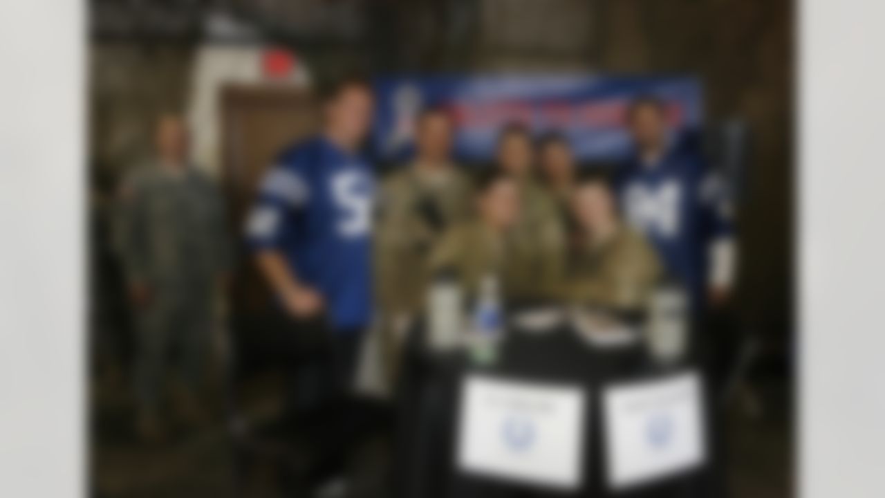 Feb 2, 2012; Edinburgh, IN, USA; Indianapolis Colts linebacker A.J. Edds (52) and tight end Jacob Tamme (84) pose for photos with members of the military during the NFL players visit to Camp Atterbury. Mandatory Credit: Brian Spurlock-US PRESSWIRE