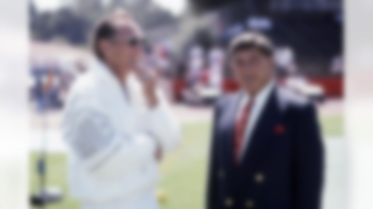 Los Angeles Raiders Hall of Fame owner Al Davis, President of the General Partner, speaks with CBS television announcer (former Kansas City Chiefs coach) Hank Stram before a 0 to 27 Los Angeles Raiders preseason loss to the San Francisco 49ers on Aug. 8, 1993 at the Candlestick Park in San Francisco. (AP Photo/Paul Spinelli)