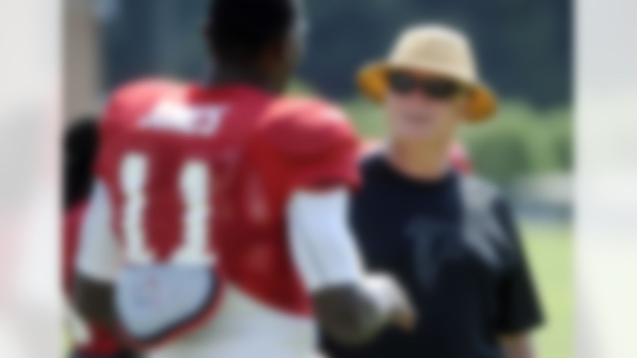 Atlanta Falcons coach Mike Smith talks to wide receiver Julio Jones during NFL football training camp, Monday, July 30, 2012, in Flowery Branch, Ga. (AP Photo/John Amis)