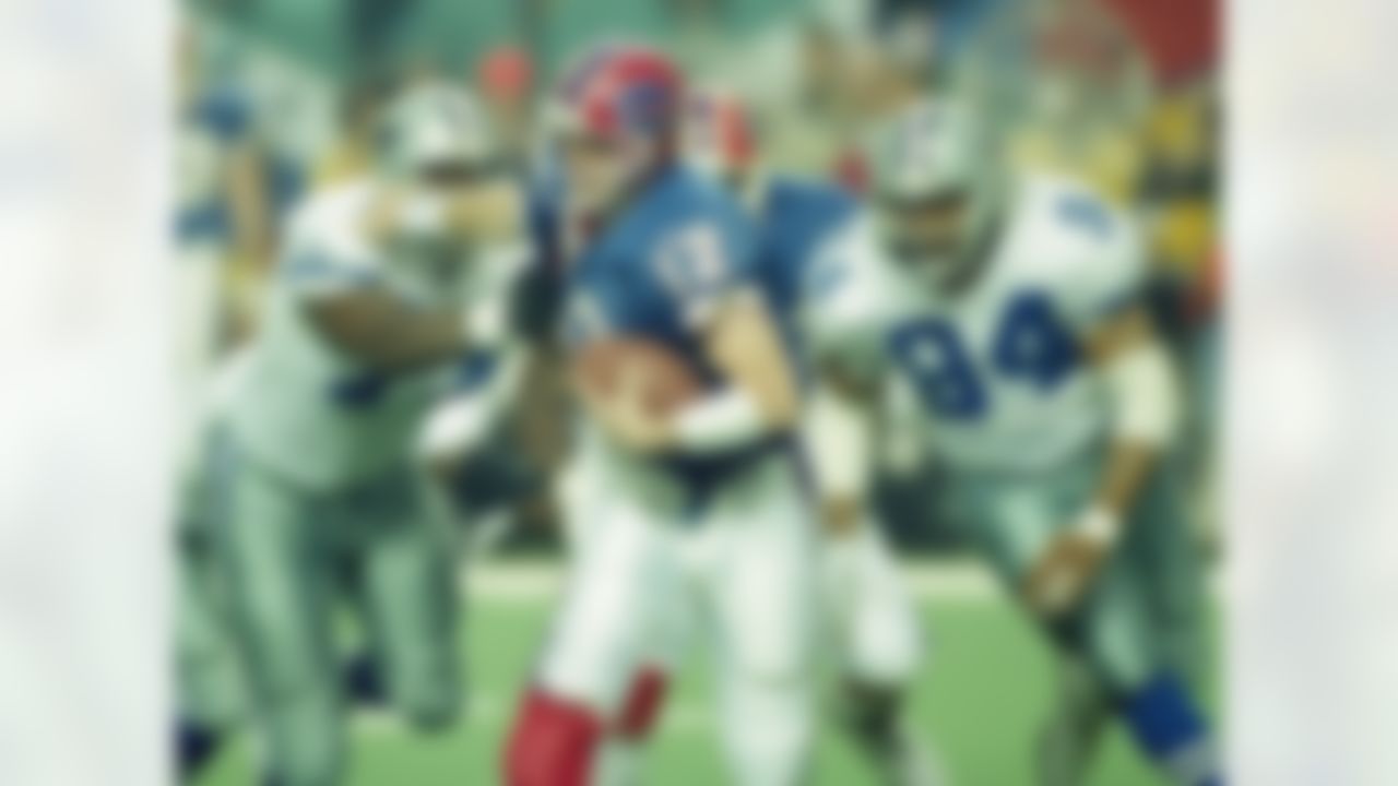 Dallas Cowboys' Jim Jeffcoat (77) and Charles Haley (94) pull down Buffalo Bills quarterback Jim Kelly during the third quarter of Super Bowl XXVIII, Jan. 30, 1994 at Atlanta's Georgia Dome. The Cowboys beat the Bills, 30-13. (AP Photo/Doug Mills)
