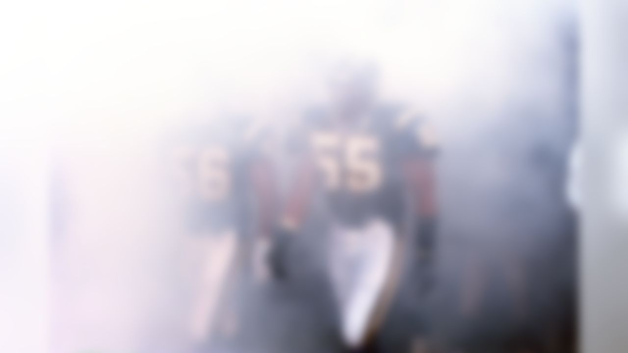 San Diego Chargers linebacker Junior Seau walks through the smoke during player introductions prior to an NFL football game against the San Francisco 49ers on August 8, 1998 in San Diego. The Chargers won 27-21. (AP Photo/G. Newman Lowrance)