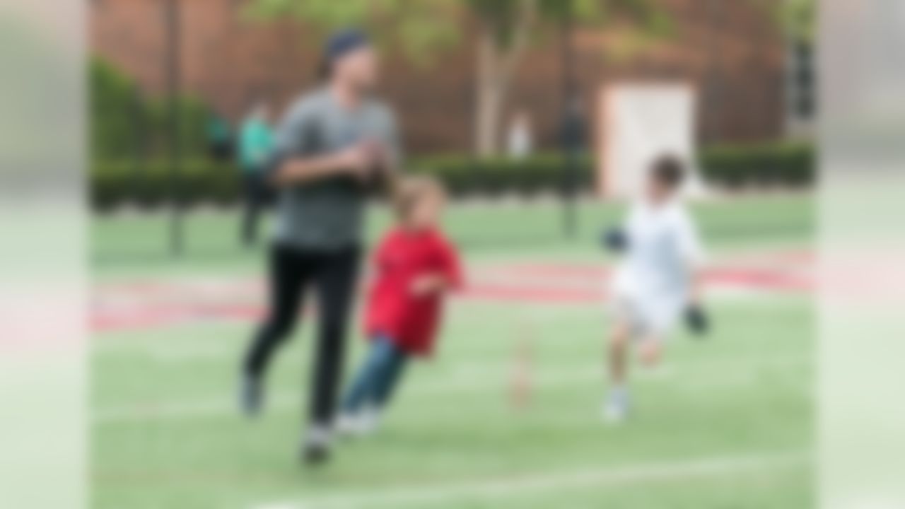 Tom Brady, left, and Jack Brady, right, participate in the Best Buddies Football Challenge at Harvard Stadium in Allston, Mass. on Friday, June 2, 2017. (Best Buddies International)