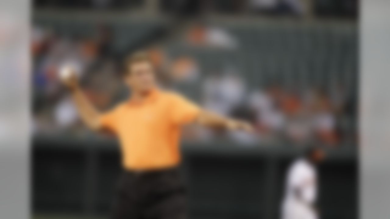 Former NFL quarterback Joe Theismann throws out the ceremonial first pitch before the start of a baseball game between the Baltimore Orioles and Los Angeles Angels Thursday, Aug. 5, 2010, in Baltimore. (AP Photo/Rob Carr)