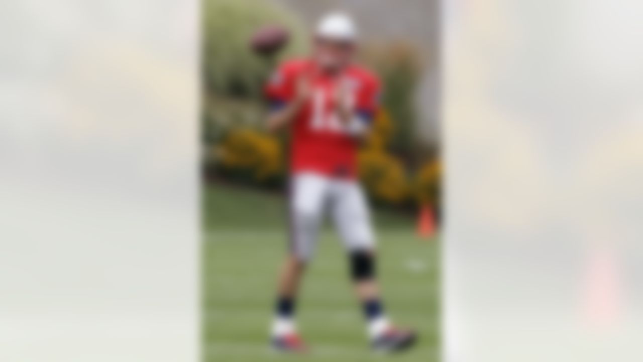 New England Patriots quarterback Tom Brady (12) catches a pass during practice on the first day of training camp at the NFL football team's facility in Foxborough, Mass., Thursday, July 26, 2012. (AP Photo/Stephan Savoia)
