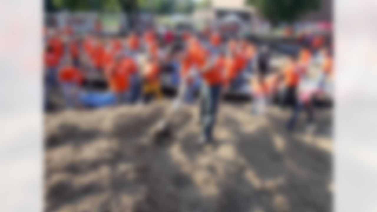 The Home Depot associates help move 145 cubic yards of mulch. (Photo by Alan Marler/CIA Stock Photography, Inc.)
