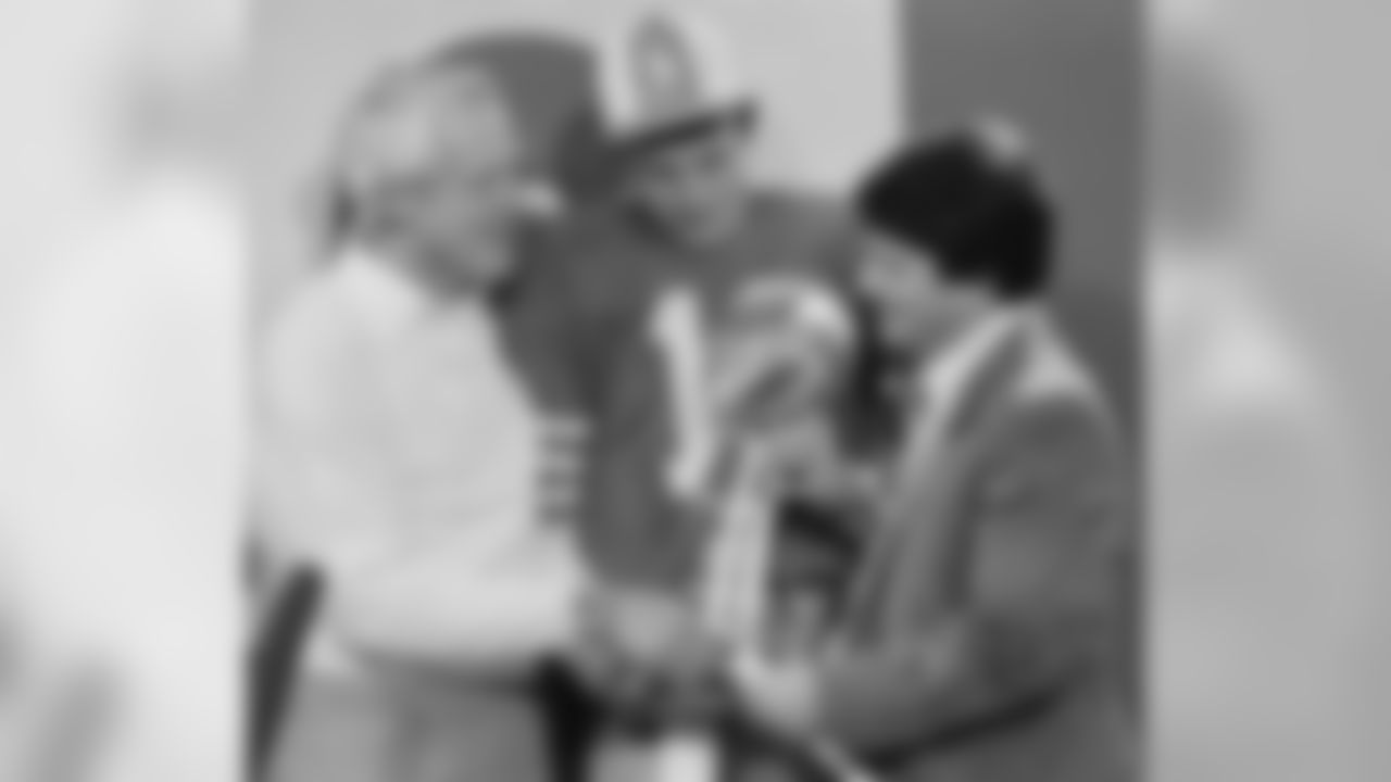 San Francisco 49ers owner Edward DeBartolo Jr. right, congratulates Coach Bill Walsh, left, and quarterback Joe Montana in locker room at Stanford Stadium on Sunday, Jan. 21, 1985 following their 38-16 Super Bowl XIX win over the Miami Dolphins. (Associated Press)