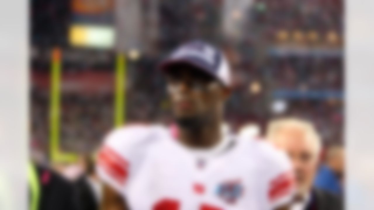 Wide receiver Plaxico Burress #17 of the New York Giants contemplates the moment while shedding tears of joy after catching the winning touchdown against the New England Patriots during Super Bowl XLII at the University of Phoenix Stadium on February 3, 2008 in Glendale, Arizona. The Giants defeated the Patriots 17-14. (AP Photo/Paul Spinelli)