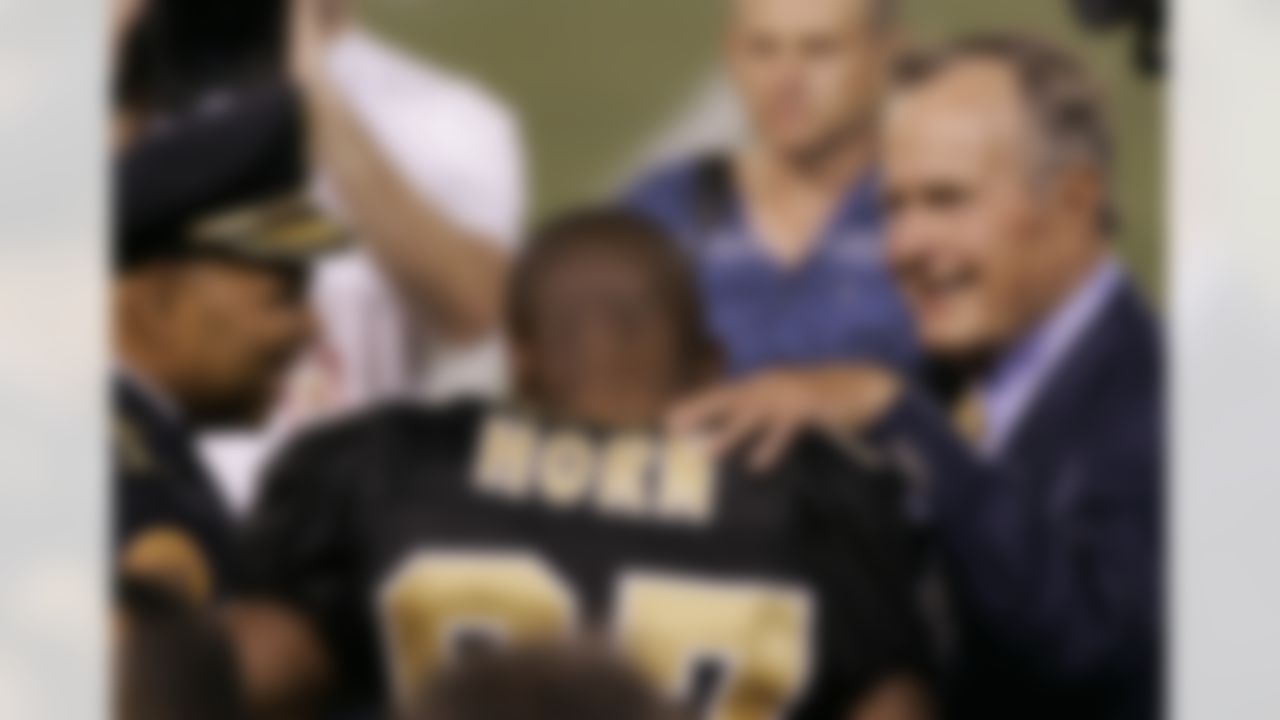 New Orleans Superintendant of Police Eddie Compass (left), New Orleans Saints wide receiver Joe Horn (center) and former President George H.W. Bush chat on the field before the coin toss for the Saints' "home" opener against the New York Giants on Monday, Sept. 19, 2005, at Giants Stadium in East Rutherford, N.J. (AP Photo/Kathy Willens)