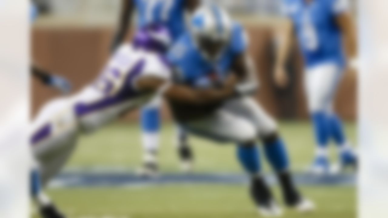 Detroit Lions running back Joique Bell (35) is tackled by Minnesota Vikings cornerback Antoine Winfield (26) during the second half at Ford Field in Detroit, Sunday, Sept. 30, 2012. (AP Photo/Rick Osentoski)