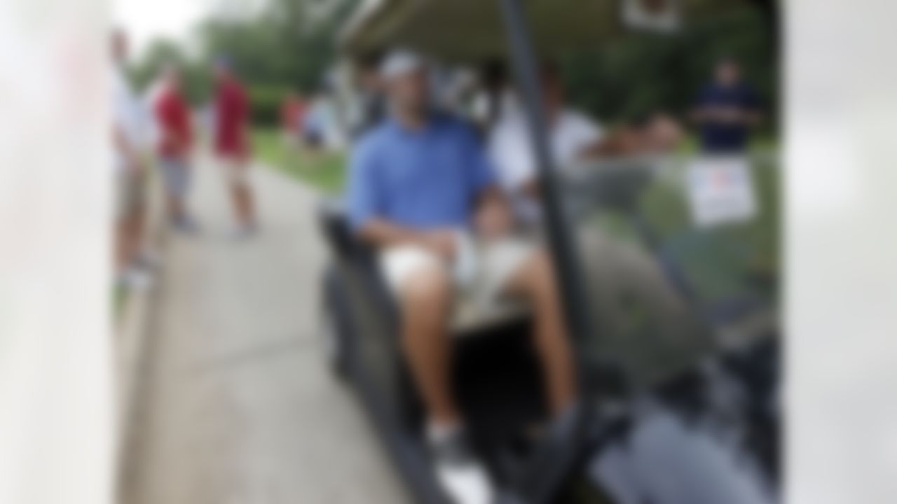 Dallas Cowboys quarterback Tony Romo, left, rides in a cart after play was suspended due to weather during sectional qualifying for the 2010 U.S. Open golf tournament Monday, June 7, 2010, at the Club at Carlton Woods in The Woodlands, Texas. The U.S. Open will be played June 14-20 at Pebble Beach Golf Links in Pebble Beach, Calif. (AP Photo/David J. Phillip)