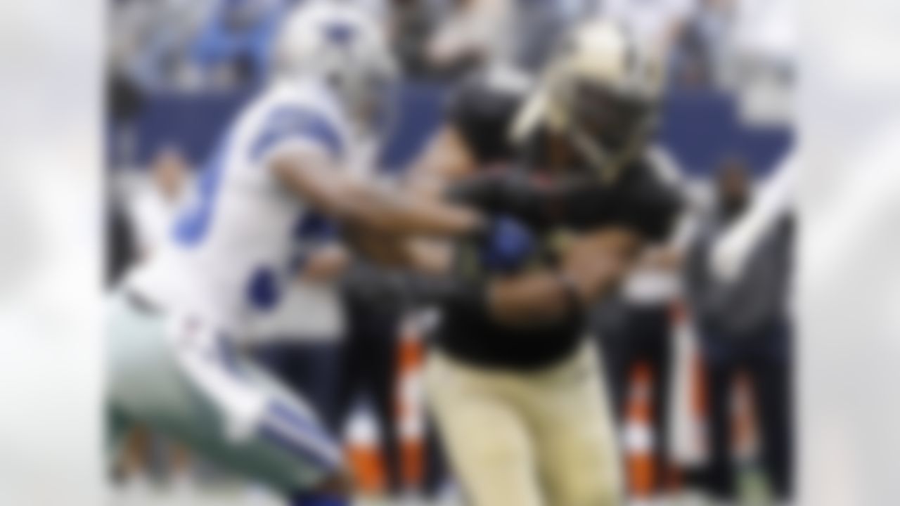 Dallas Cowboys cornerback Brandon Carr (39) slows New Orleans Saints running back Mark Ingram (28) during the first half of an NFL football game Sunday, Dec. 23, 2012 in Arlington, Texas. (AP Photo/Brandon Wade)