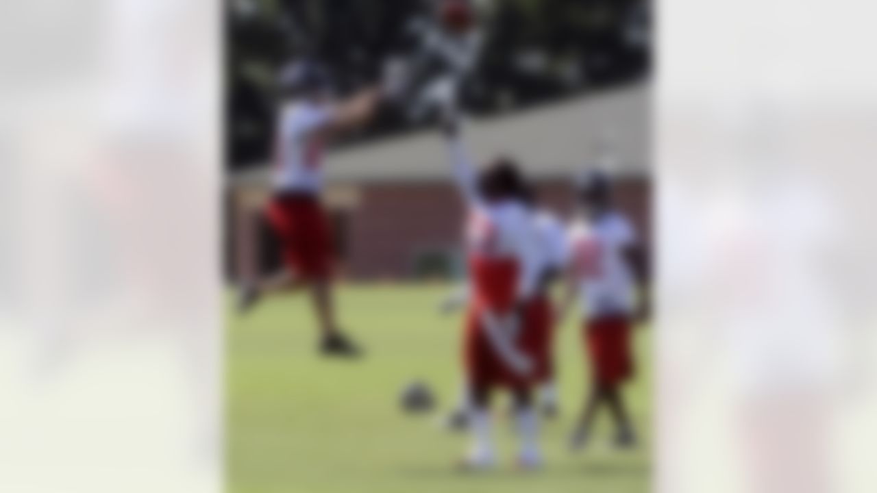 Atlanta Falcons cornerback Brent Grimes, left, and linebacker Mike Peterson (53) play around between drills during NFL football training camp on Saturday, July, 28, 2012. (AP Photo/John Amis)