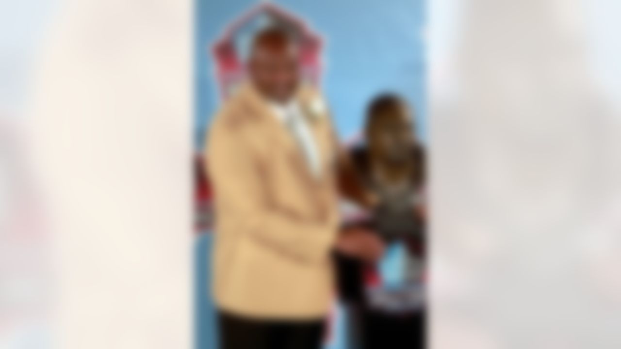 Dermontti Dawson poses for a photograph with his bust at the 2012 Hall of Fame Enshrinee Ceremony at Fawcett Stadium in Canton, Ohio on August 4, 2012. (Ben Liebenberg/NFL)