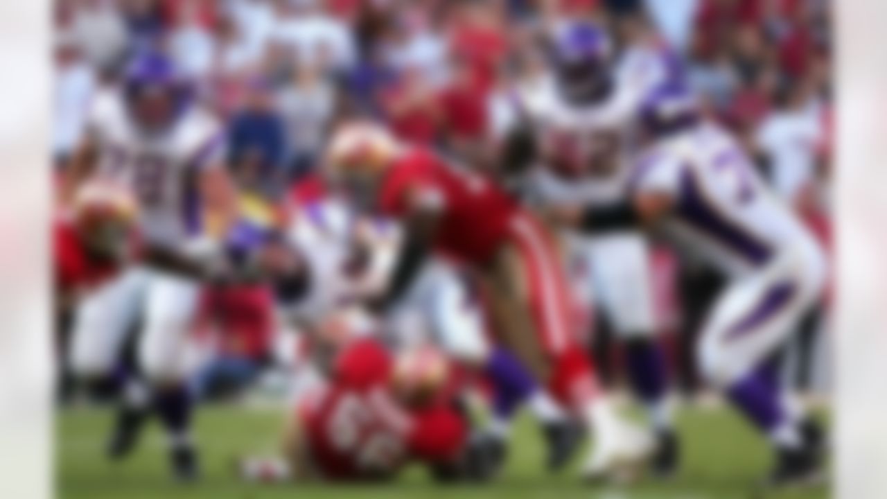 SAN FRANCISCO - NOVEMBER 05: Brad Johnson #14 of the Minnesota Vikings fumbles the ball against the defense of Brandon Moore #56 and Bryant Young #97 of the San Francisco 49ers in the fourth quarter of the NFL game at Monster Park on November 5, 2006 in San Francisco, California. The 49ers recovered the ball on the play. Photo by Getty Images.