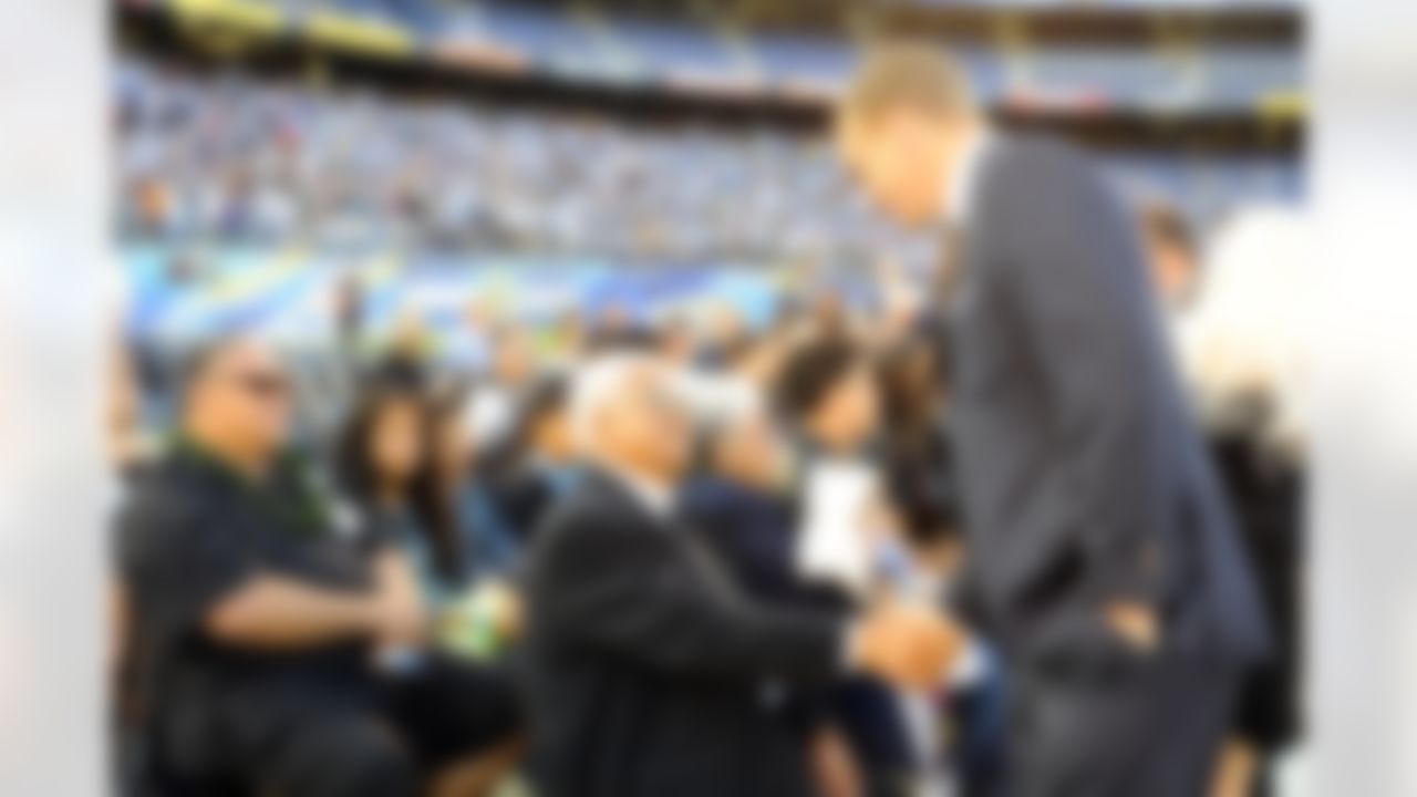 May 11, 2012; San Diego, CA, USA; Denver Broncos quarterback Peyton Manning shakes hands with Tiaina Seau, father of Junior Seau, prior to a celebration of life service to remember Junior Seau at Qualcomm Stadium. Mandatory Credit: Christopher Hanewinckel-US PRESSWIRE