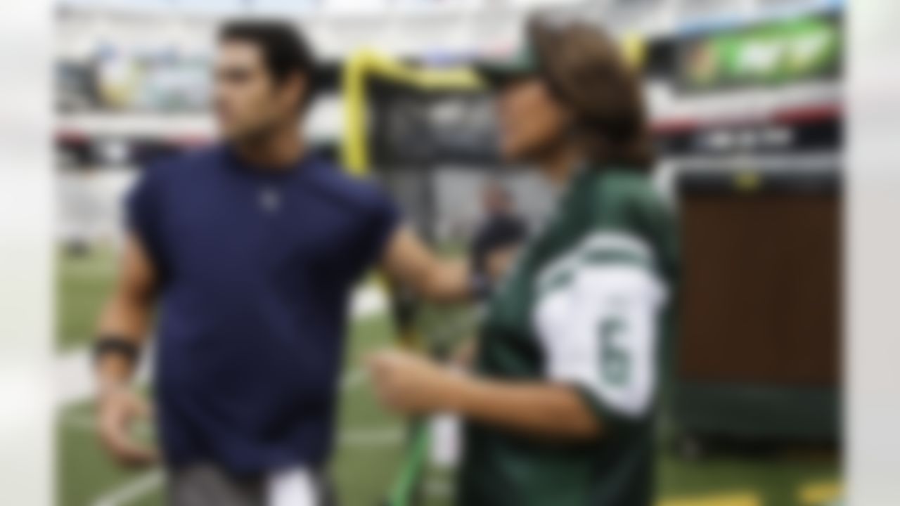 New York Jets quarterback Mark Sanchez, left, and his mother, Olga Macias, right, look on before an NFL football game between the Jets and the Jacksonville Jaguars at MetLife Stadium Sunday, Sept. 18, 2011, in East Rutherford, N.J. (AP Photo/Julio Cortez)