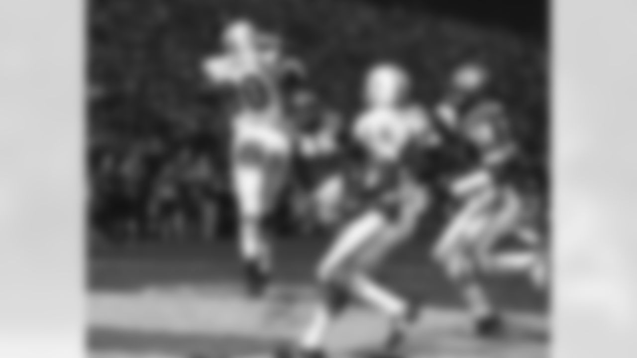 Miami's Marv Fleming (80) leaps to take a pass from Bob Griese for a first-down gain in the playoff game with the Kansas City Chiefs in Kansas City, Dec. 25, 1971. Rushing into make the drop is Jim Kearney (46). Play turned out to be a touchdown. The Dolphins beat the Kansas City Chiefs, 27-24 in overtime. (AP Photo)