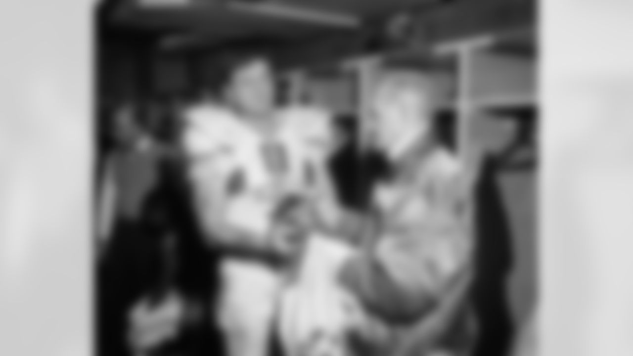 Chuck Bednarik of the Philadelphia Eagles hands his jersey and shoes to equipment manager Freddie Schubach in St. Louis, Dec. 16, 1962 after game which the St. Louis Cardinals won 45-35. The game was Bednarik's last. The jersey and the shoes will be placed in the Football Hall of Fame. (Associated Press)
