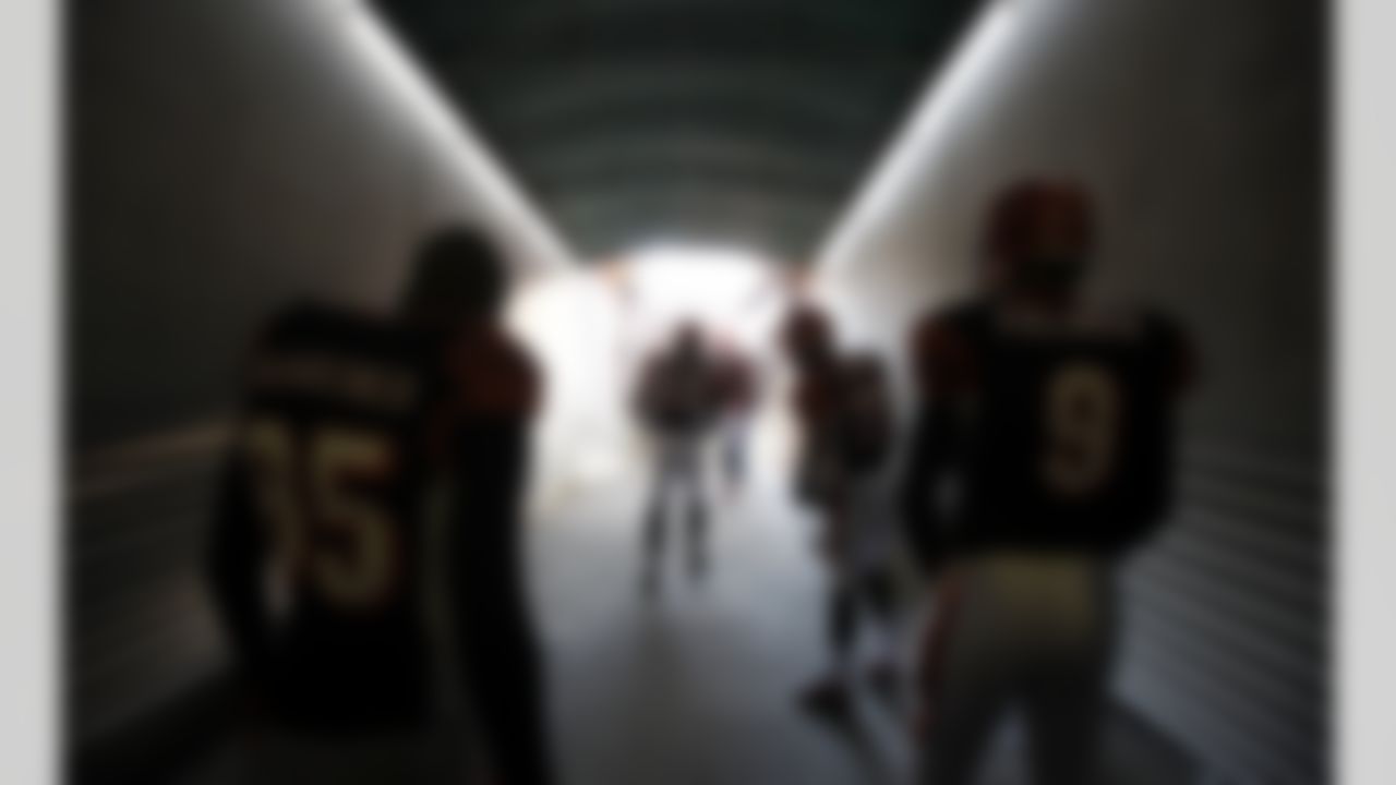 Cincinnati Bengals wide receiver Chad Ochocinco (85) and quarterback Carson Palmer (9) wait to be introduced before the start of an NFL wild-card playoff football game against the New York Jets, Saturday, Jan. 9, 2010, in Cincinnati.(AP Photo/Rob Carr)