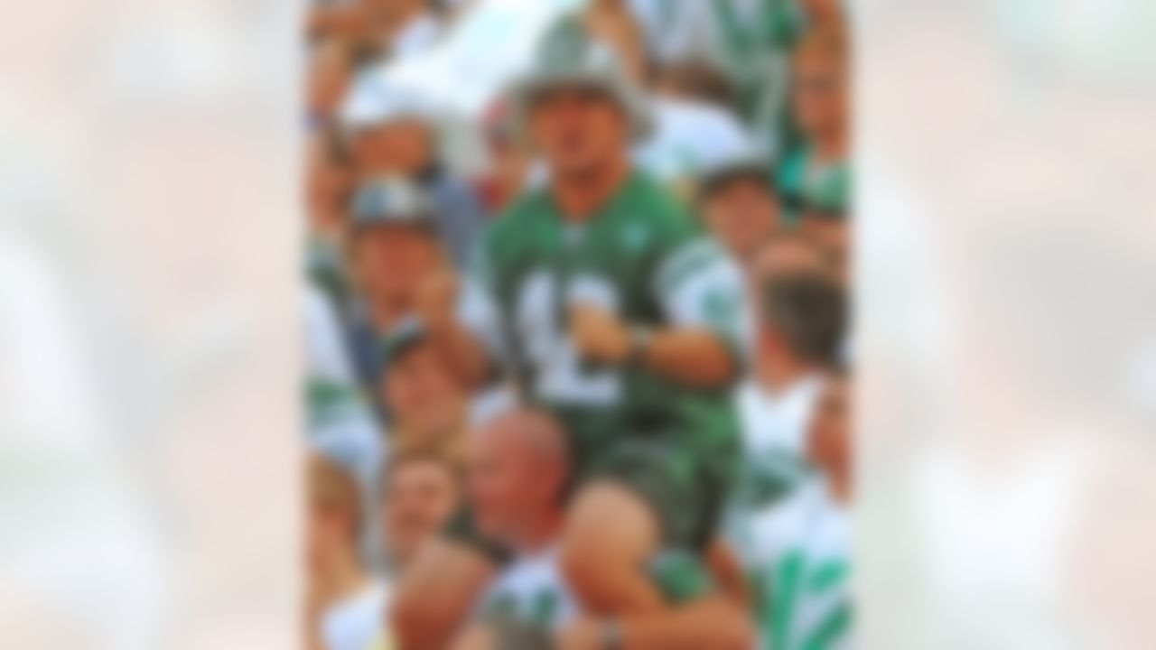 Fireman Ed Anzalone, the ultimate New York Jets fan and cheerleader, sits on another fan's shoulders as the Jets play the New England Patriots at Giants Stadium in East Rutherford, N.J., Sept. 14, 2008. The Jets lost their home opener 19-10. (AP Photo/Dick Druckman)