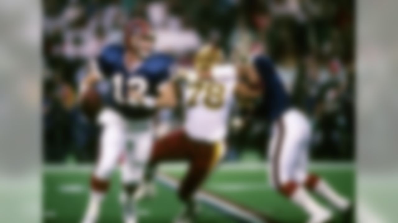 Hall of Fame quarterback Jim Kelly (12) of the Buffalo Bills rolls out to elude defensive pressure during the Bills 37-24 loss to the Washington Redskins in Super Bowl XXVI on January 26, 1992 at the Hubert H. Humphrey Metrodome in Minneapolis, Minnesota. (National Football League)