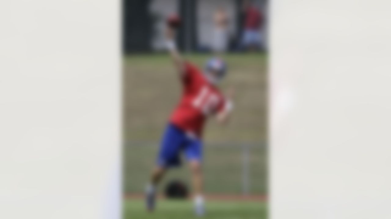New York Giants quarterback Eli Manning (10) passes the ball during a practice at NFL football training camp in Albany, N.Y., Friday, July 27, 2012. (AP Photo/Kathy Willens)