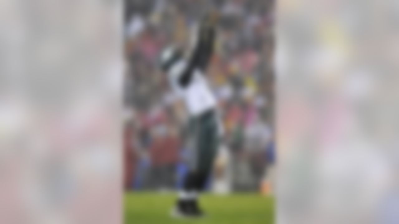 Philadelphia Eagles quarterback Michael Vick celebrates throwing a touchdown pass against the Washington Redskins during the second half of an NFL football game, Monday, Nov. 15, 2010, in Landover, Md. The Eagles won 59-28. (AP Photo/Gail Burton)