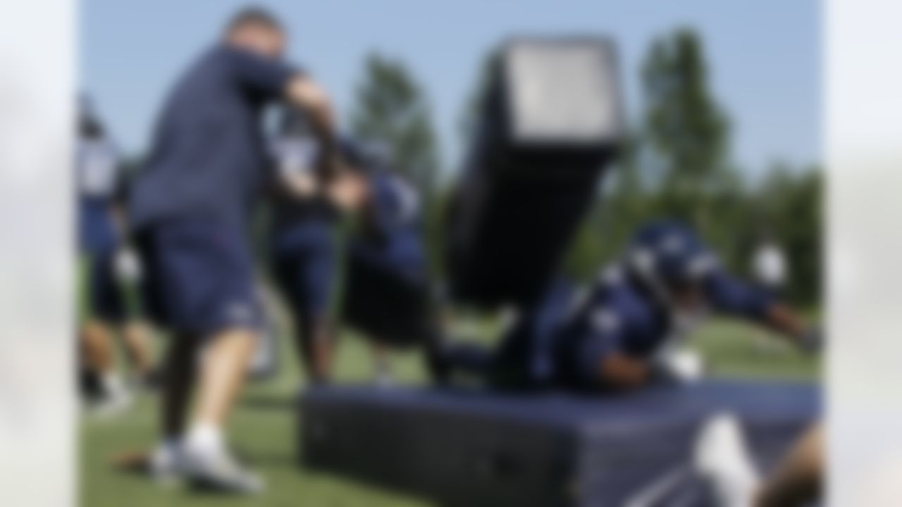 Seattle Seahawks tight end Cameron Morrah, right, takes out a blocking pad as he works with tight end coach Pat McPherson, left, Friday, Aug. 3, 2012, during NFL football training camp drills in Renton, Wash. (AP Photo/Ted S. Warren)