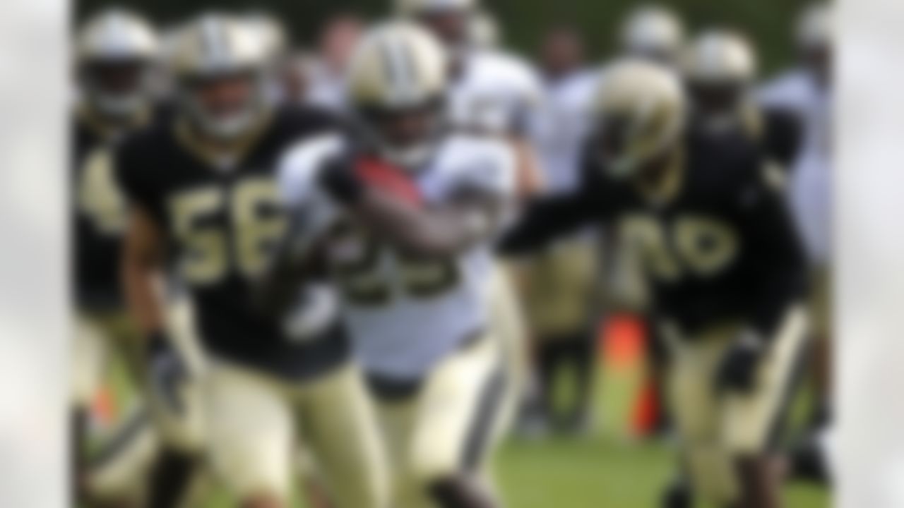 New Orleans Saints running back Chris Ivory (29) rushes past outside linebacker Jo-Lonn Dunbar (56) during training camp at their NFL football training facility in Metairie, La., Saturday, July 28, 2012. (AP Photo/Gerald Herbert)