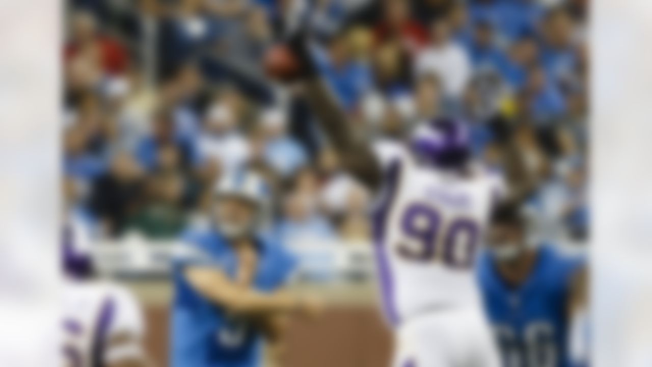 Minnesota Vikings nose tackle Fred Evans (90) blocks a pass by Detroit Lions quarterback Matthew Stafford (9) during the second half at Ford Field in Detroit, Sunday, Sept. 30, 2012. (AP Photo/Rick Osentoski)