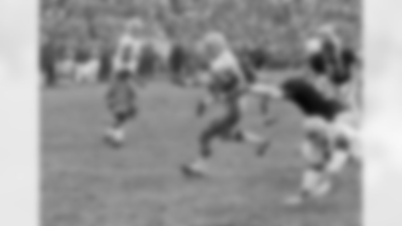 Bears linebacker Dick Butkus (51) partially evades a block by Green Bay guard Dave Bradly (61), but his one hand isn?' enough to stop Packers' running back Donny Anderson. Anderson broke loose and carried the ball in for a touchdown, Dec. 14, 1970 in Chicago. Watching the play are Bears' Doug Buffone (55) and Willie Holman (85), and Packers' guard Gale Gillingham (68). The Bears won 35-17. (AP Photo/Fred Jewell)