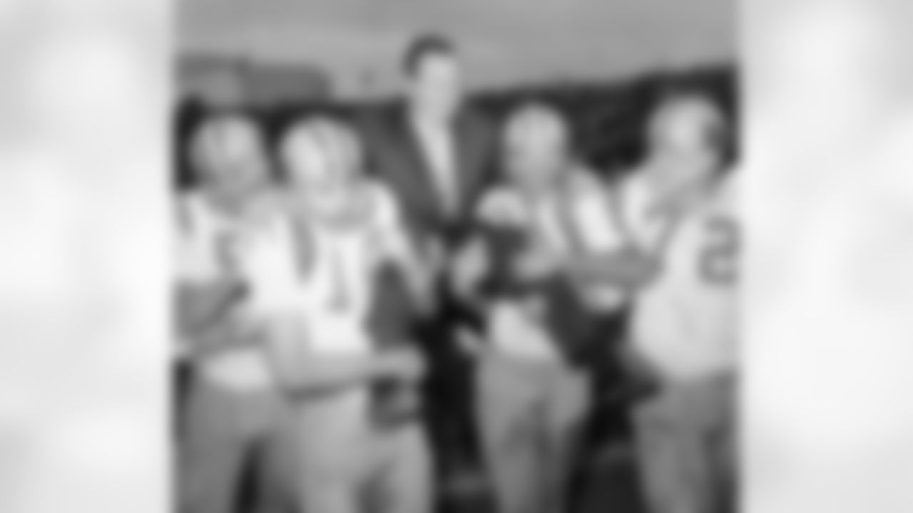 LSU Tigers' head coach Charles McClendon is carried off the field by members of his team after they defeated the University of Texas 13-0 in the Cotton Bowl in Dallas, Jan. 1, 1963. Players are: Jimmy Field (14); Bill Truax (84); and Rodney Guillot. (Associated Press)