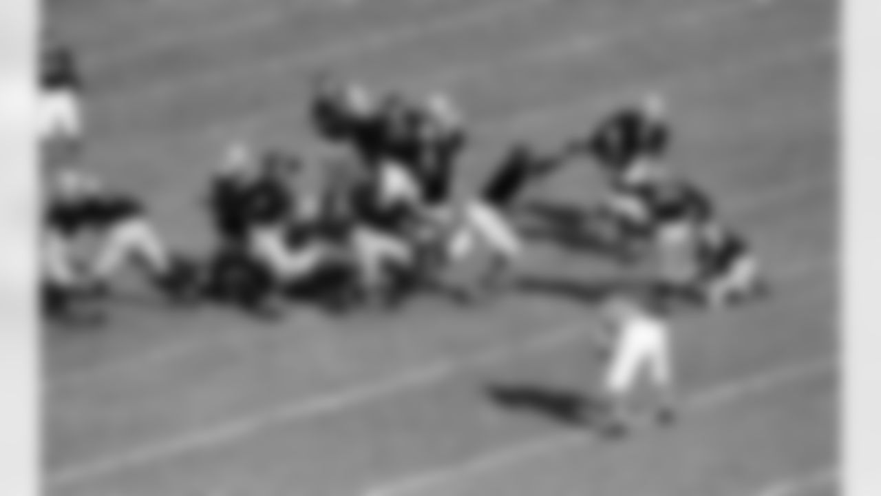 The Green Bay Packers, line failed to hold when Clark Hinkle (3), Packers back, tired a field goal in the first period of the western division title game with the Chicago bears in Chicago, on Dec. 14, 1947. The Bears won 33-14. Here John Siegel, Bear end, rushes in on ball as it leaves Hinkle's foot, with teammate Dick Plasman (14), Dan Fortmann (21) and Ed Kolman (29) backing him up the ball down on the Bears 31. No. 8 of Packers is Herman Rohrig, back. (Associated Press)
