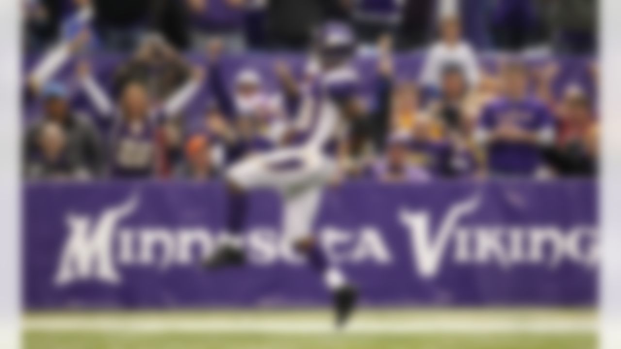 Adrian Peterson celebrates as he scores on a 61-yard touchdown run in the second half of an NFL football game against the Detroit Lions in Minneapolis. (AP Photo/Genevieve Ross, File)