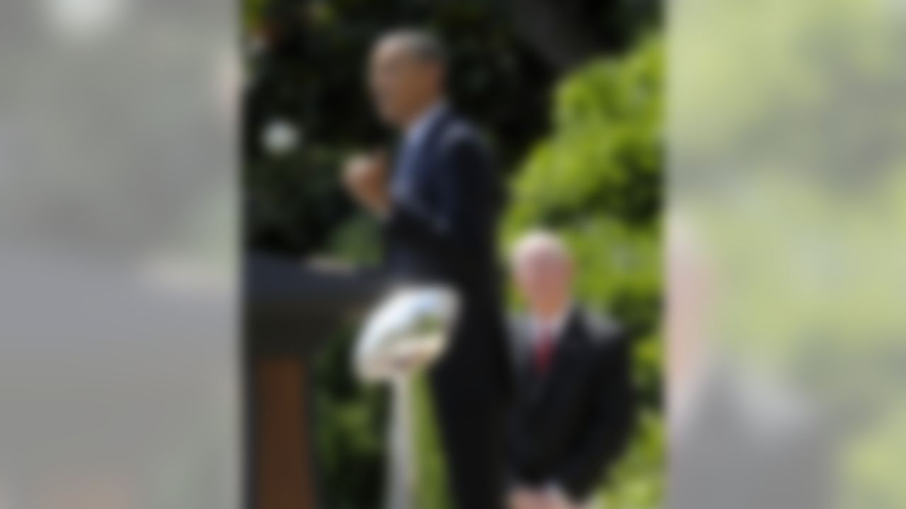 With the Super Bowl trophy in the foreground, and New York football Giants head coach Tom Coughlin in the background, President Barack Obama speaks on the South Lawn at the White House in Washington, Friday, June 8, 2012, during a ceremony honoring the Super Bowl XLVI Champions. (AP Photo/Susan Walsh)