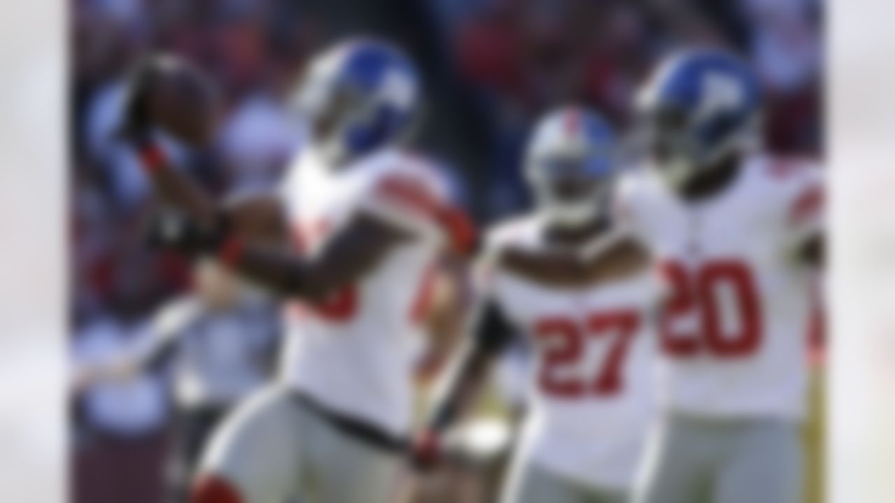 New York Giants free safety Antrel Rolle, left, celebrates with cornerback Prince Amukamara (20) after intercepting San Francisco 49ers quarterback Alex Smith during the third quarter of an NFL football game in San Francisco, Sunday, Oct. 14, 2012. (AP Photo/Marcio Jose Sanchez)