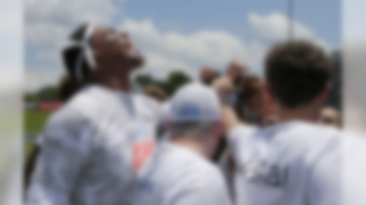 Carolina Panthers quarterback Cam Newton, left, fires up his team during the Cam Newton Foundation's Kicking It with Cam! Celebrity Kickball Tournament in Charlotte, N.C., Friday, June 9, 2017. The charity tournament was made up of 18 teams comprised of Carolina Panthers and Charlotte Hornets players, celebrity athletes, entertainers, business professionals and community leaders.(AP Photo/Chuck Burton)