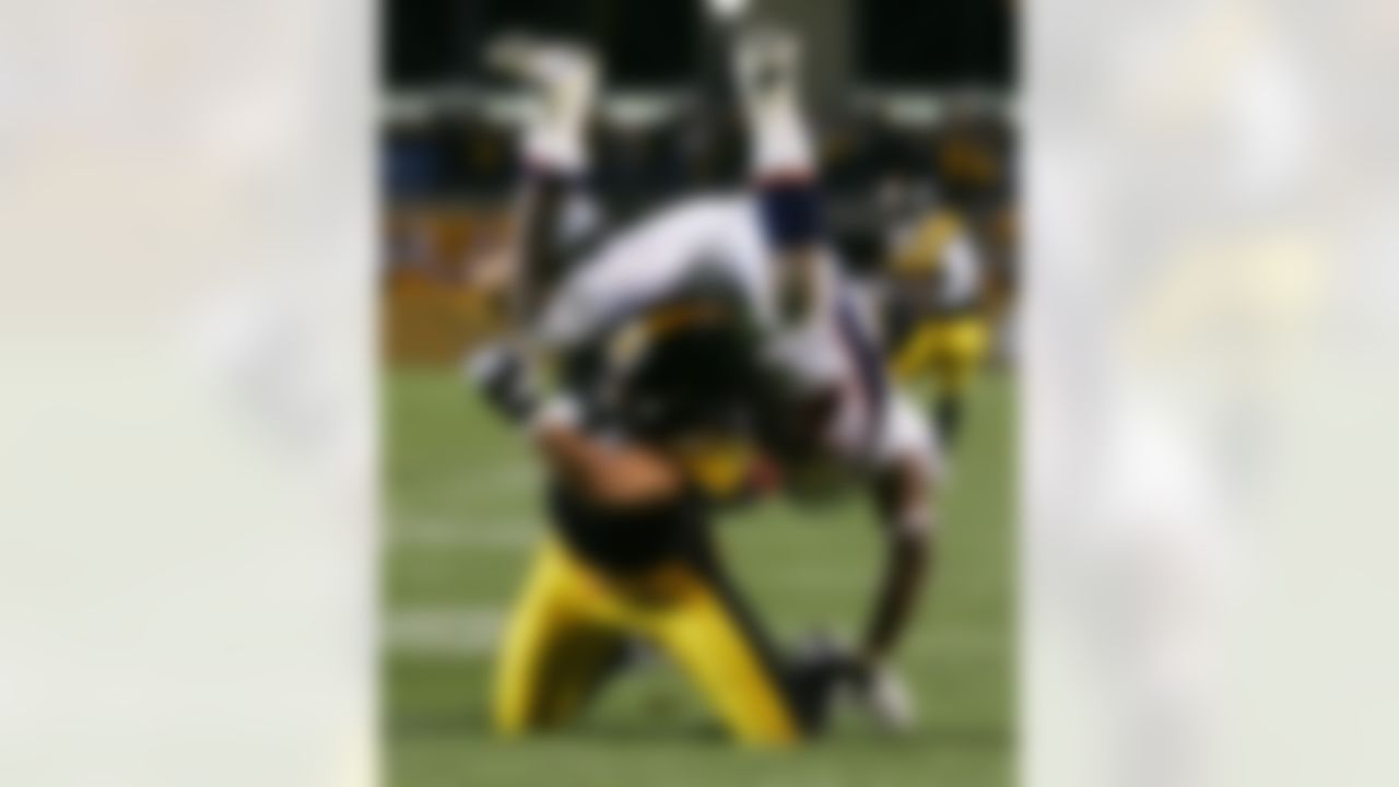 PITTSBURGH - NOVEMBER 05: Troy Polamalu #43 of the Pittsburgh Steelers upends Mike Bell #20 of the Denver Broncos as he runs the ball during thier game on November 5, 2006 at Heinz Field in Pittsburgh, Pennsylvania. Photo by Getty Images.