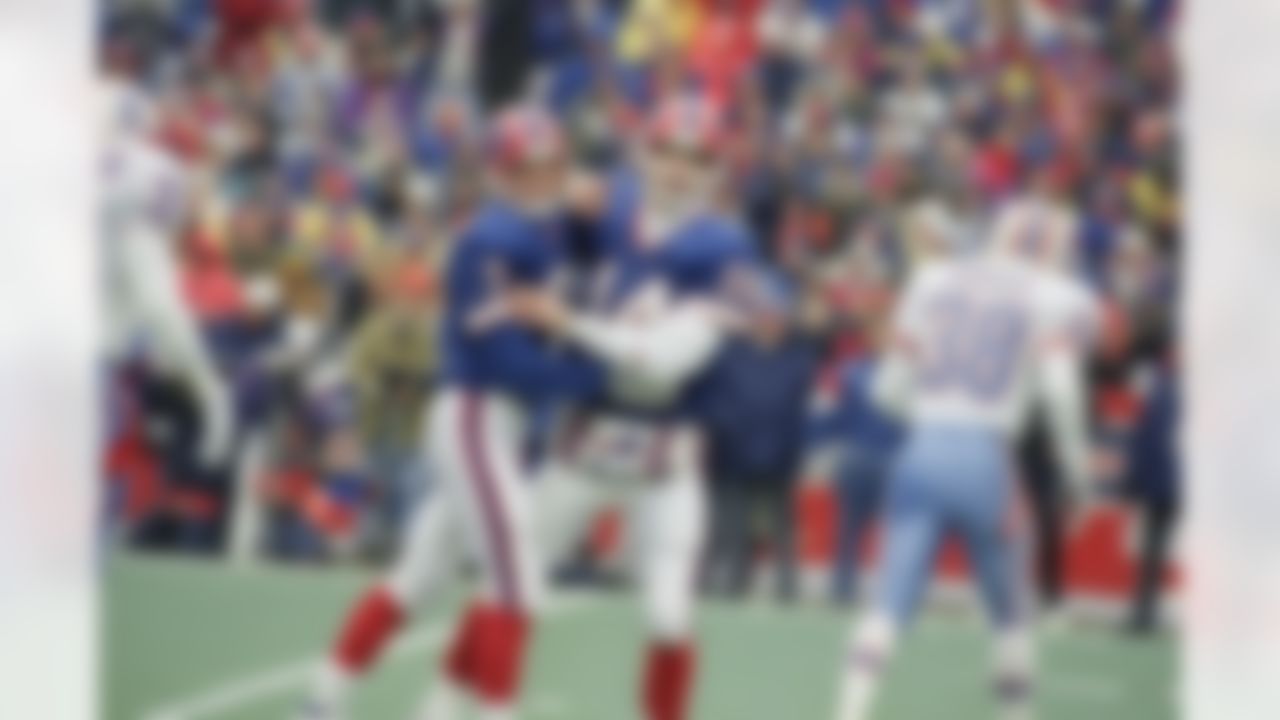 Buffalo Bills kicker Steve Christie, left, and quarterback Frank Reich celebrates Christie's first quarter field goal against the Houston Oilers on Sunday, Jan. 3, 1993 at Rich Stadium in Orchard Park. Reich engineered the greatest comeback in NFL history and Christie kicked the winning field goal in overtime to beat the Oilers 41-38. (AP Photo/John Hickey)