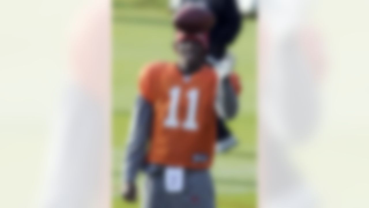Tampa Bay Buccaneers' Josh Johnson catches a ball during a team training session, Bagshot, west of London, Thursday Oct. 20, 2011. The Buccaneers will face Chicago Bears at London's Wembley stadium on Sunday. (AP Photo/Tom Hevezi)